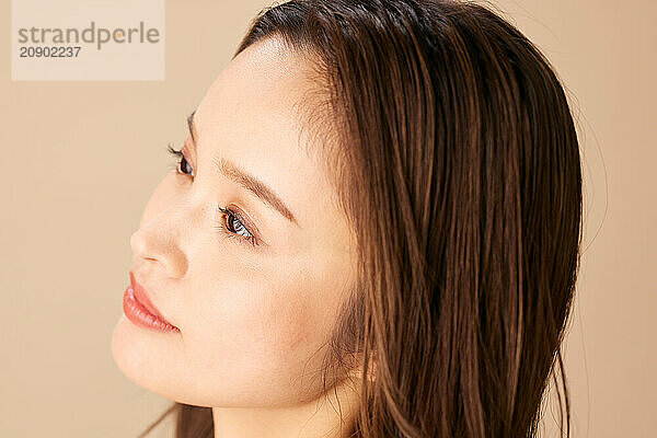 Asian Woman With Long Brown Hair Looking Up