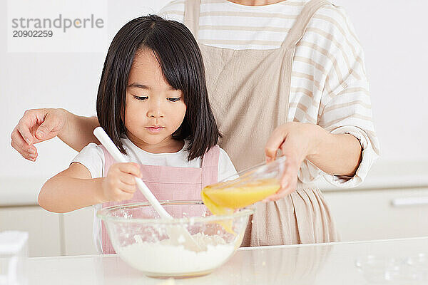 Japanese mother and daughter cooking in the kitchen