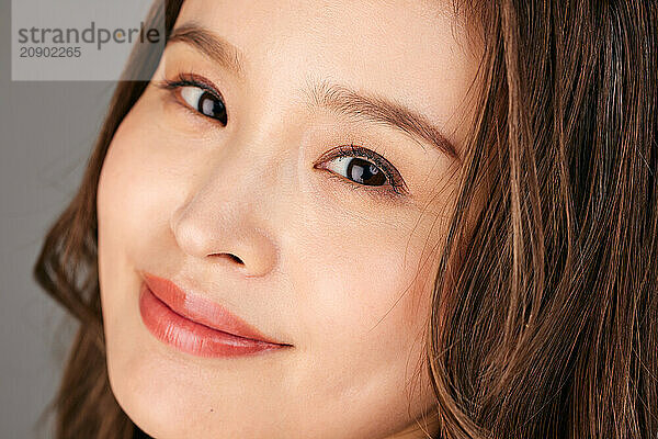 Asian Woman With Long Brown Hair And A Smile