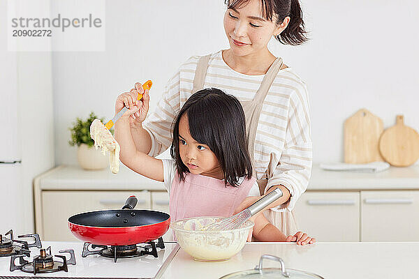 Japanese mother and daughter cooking in the kitchen