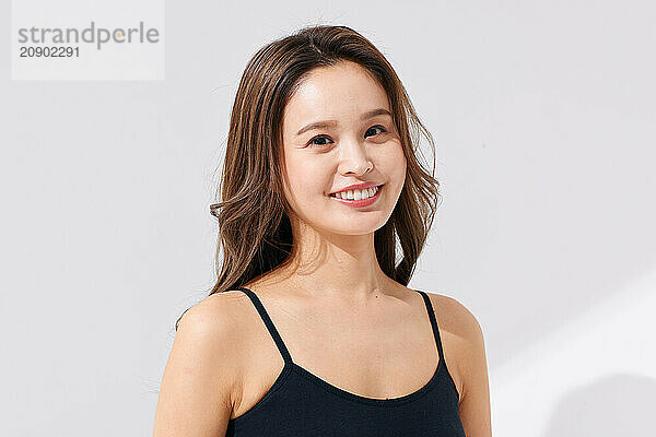 Asian Woman In A Black Bra Top Smiling