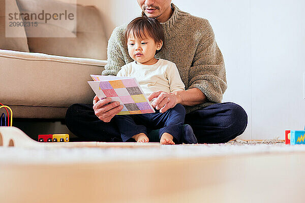 Japanese father and son reading a book