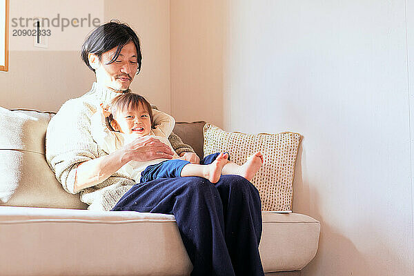 Japanese father and son on the sofa