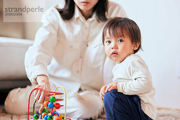 Asian child playing with wooden toys