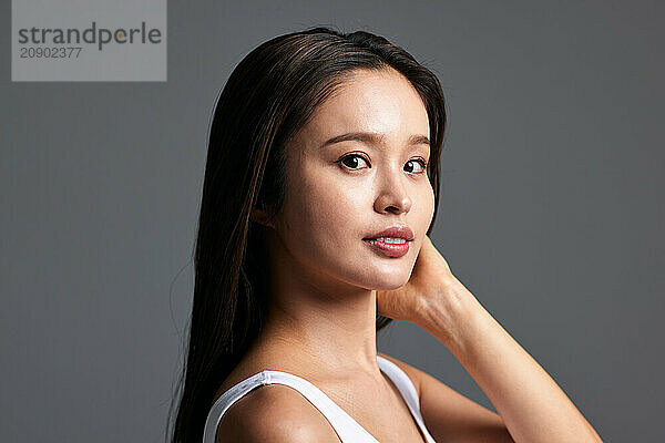 Asian Woman With Long Hair Posing For The Camera