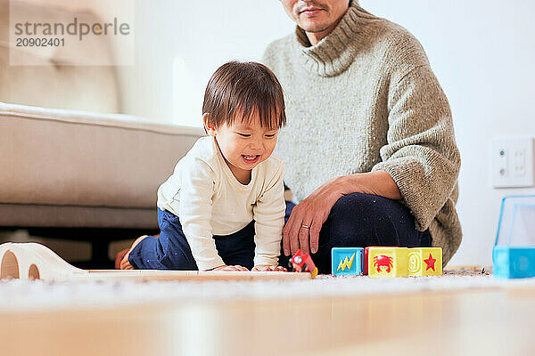 Asian child playing with wooden toys