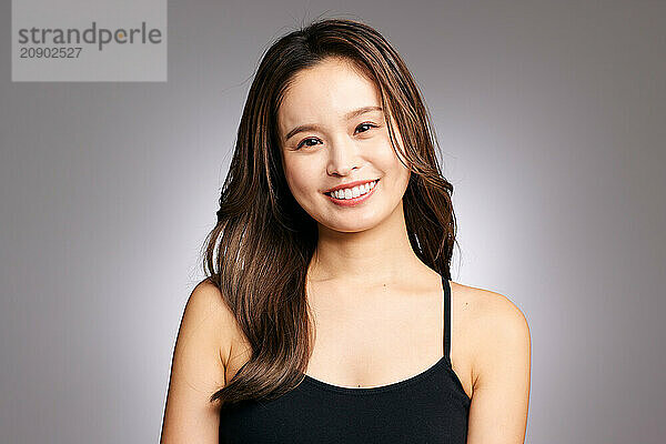 Asian Woman In A Black Tank Top Smiling