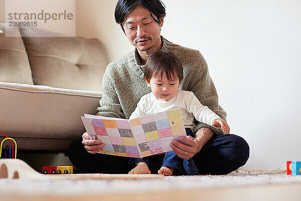 Japanese father and son reading a book