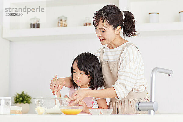 Japanese mother and daughter cooking in the kitchen