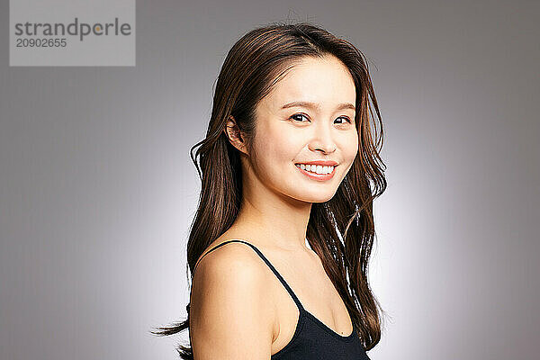 Asian Woman In A Black Top Smiling