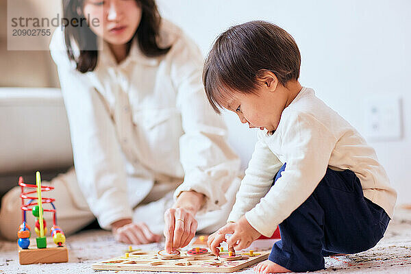 Asian child playing with wooden toys