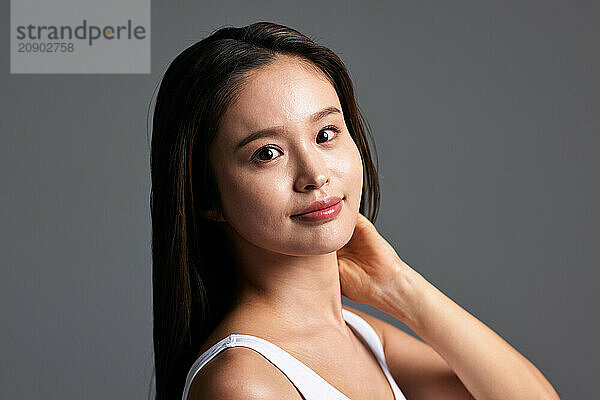 Asian Woman With Long Hair And A White Tank Top