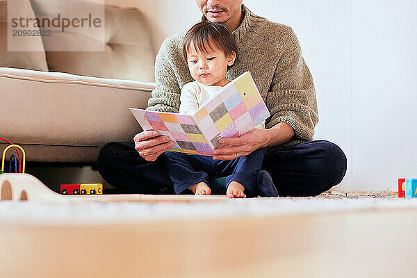 Japanese father and son reading a book