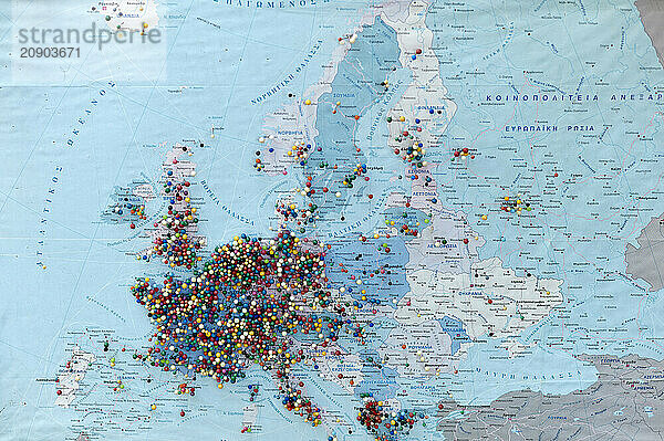 Colorful pushpins clustered on a map of Europe  suggesting a multitude of travel destinations or points of interest.