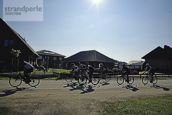 Cyclists  group  country road  backlight