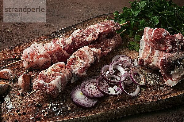 Raw pork meat  on wooden sticks  pickled kebab  with spices  top view  no people