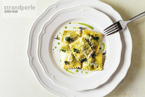 Ravioli mit Spinat und Käse  grüne Soße  auf einem hellen Hintergrund  selektiver Fokus  keine Menschen