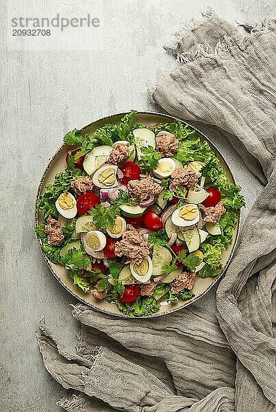 Thunfischsalat  Gemüsesalat mit Wachteleiern  Kopfsalat  roten Zwiebeln und Gurken  auf einem hellgrauen Tisch  Keto Food  Lifestyle  gesunde Ernährung  selektiver Fokus  Draufsicht  keine Menschen