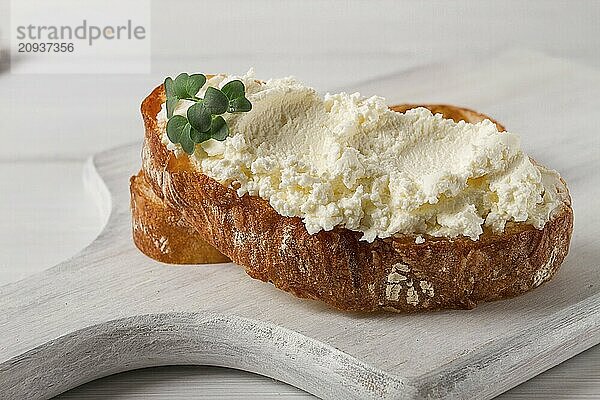 Sandwich  mit Frischkäse  hausgemacht  auf einem Schneidebrett  rustikal  ohne Menschen  selektiver Fokus  Frühstück