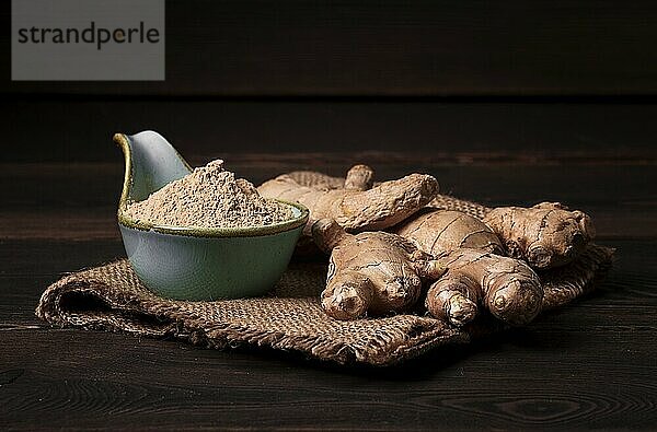 Ground and fresh ginger root  on a wooden table  rustic style  selective focus  no people