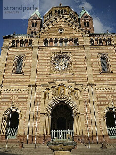 Frontal view of a gothic sandstone cathedral façade with towers under a blue sky  large cathedral with two towers in front of a blue sky with clouds  Speyer  Germany  Europe