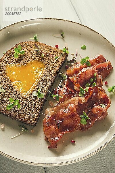 Frühstück  Spiegelei mit Speck  mikro grün  auf einem hellen Hintergrund  keine Menschen  selektiver Fokus