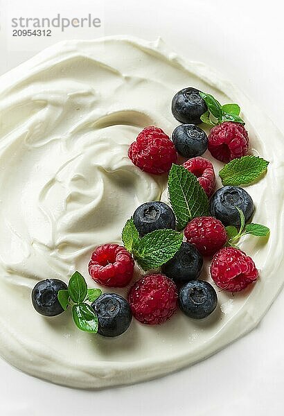 Frühstück  Joghurt mit frischen Beeren  Himbeeren und Heidelbeeren  auf einem weißen Hintergrund  selektiver Fokus  keine Menschen  gesunde Lebensmittel