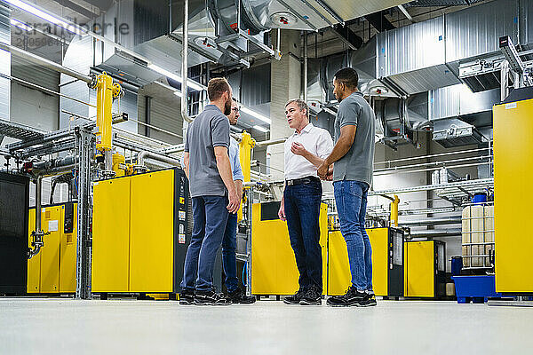 Businessmen and employees having a meeting in factory