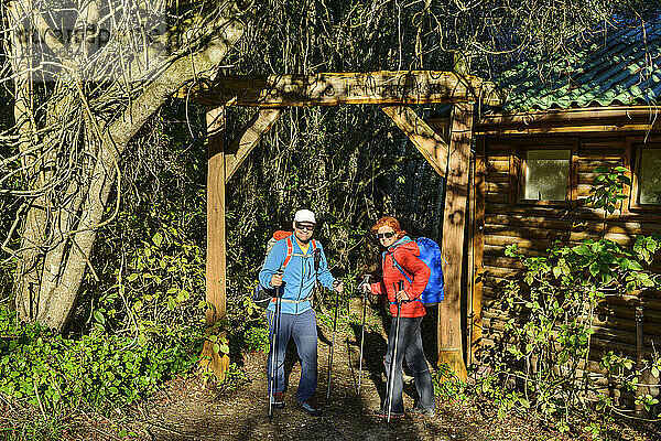 Smiling mature hikers standing at entrance of Otter trail in Eastern Cape  South Africa