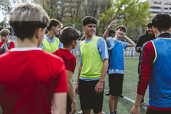 Happy soccer players standing on field