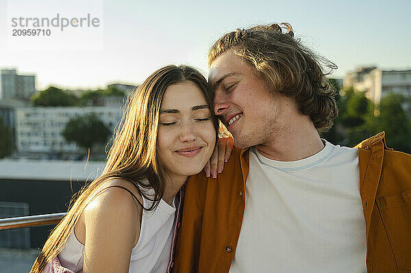 Couple enjoying ride on ferris wheel at amusement park