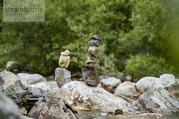 Rock cairns at river stream in forest