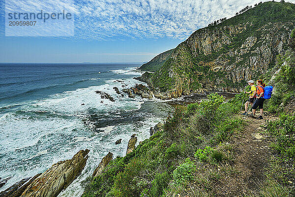 Hikers looking at Bloukrans River standing on trail by mountains in Tsitsikamma Section  Garden Route National Park  Eastern Cape  South Africa