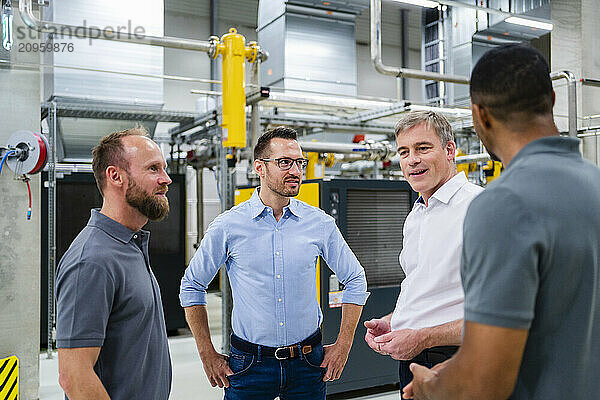 Businessmen and employees having a meeting in factory