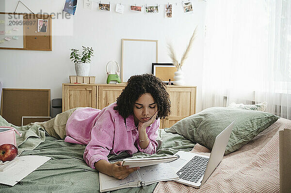 Teenage girl doing homework at home