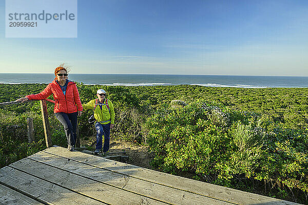 Man and woman hiking on Cannon Rocks trail at Addo Elephant National Park in Eastern Cape  South Africa