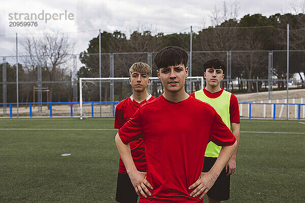 Soccer players standing together on field