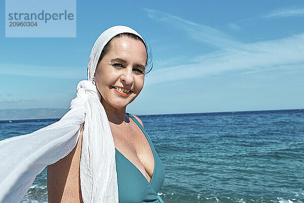 Smiling woman enjoying vacation on beach at sunny day