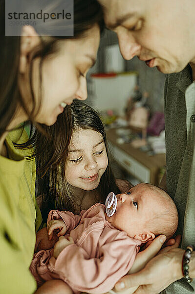 Parents spending leisure time with daughter's at home