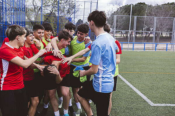 Happy soccer players having fun on field