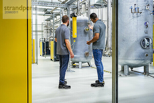 Two employees talking in factory