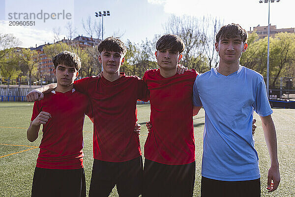 Soccer players standing together on field