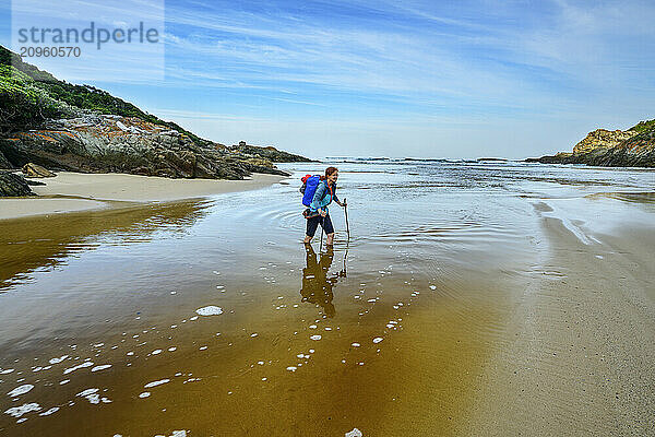 Carefree hiker crossing Elandsbos river at Otter trail in Tsitsikamma Section  Garden Route National Park  Eastern Cape  South Africa