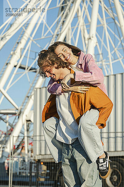 Happy couple enjoying together in amusement park