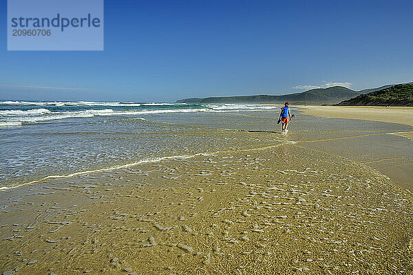 Woman walking at seashore in Tsitsikamma Section  Garden Route National Park  Eastern Cape  South Africa