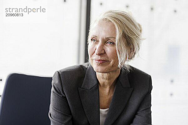 Smiling businesswoman with blond hair at office