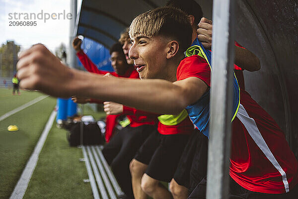 Happy soccer players cheering and celebrating victory goal