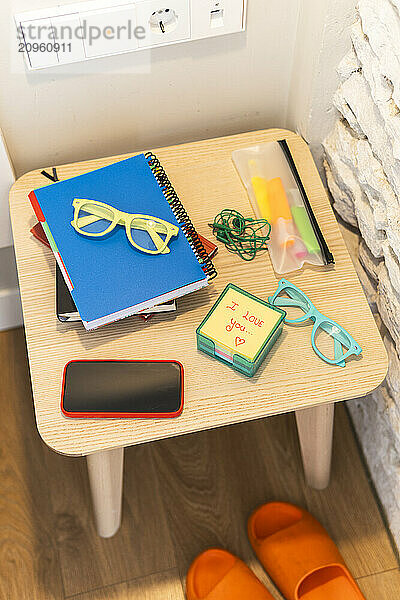 Group of objects on wooden stool in hotel room