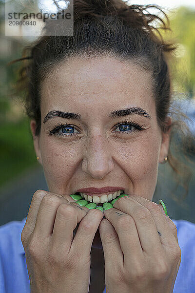 Young woman biting nails