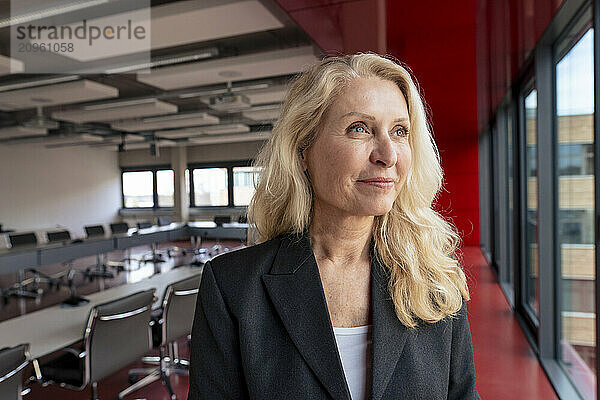 Blond thoughtful businesswoman at office